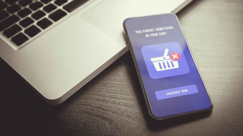 Cart Abandonment Email Reminder – A smartphone screen showing a cart abandonment email with a "checkout now" button for e-commerce businesses.